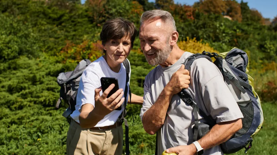 two active seniors share a moment on their nature hike