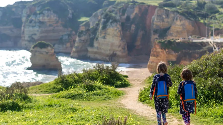 two young girls exploring portuguese coastline praia dona ana lagos