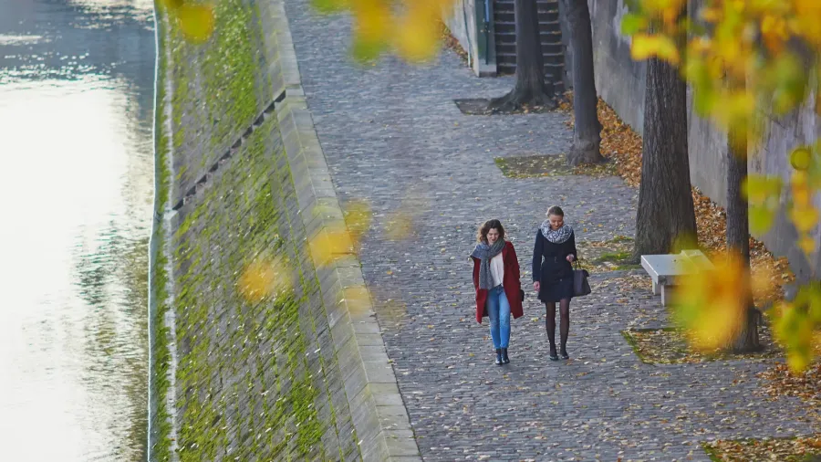 two young girls walking together in paris