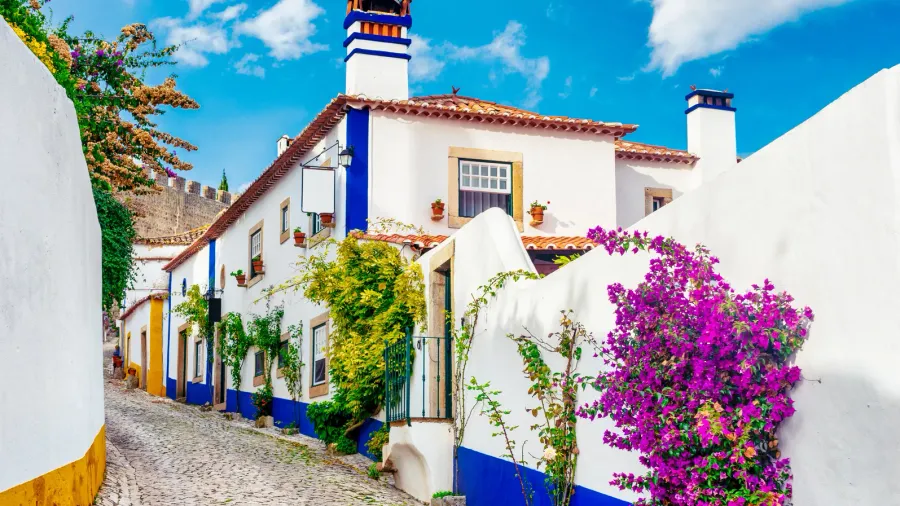 typical street of the medieval village of obidos in portugal