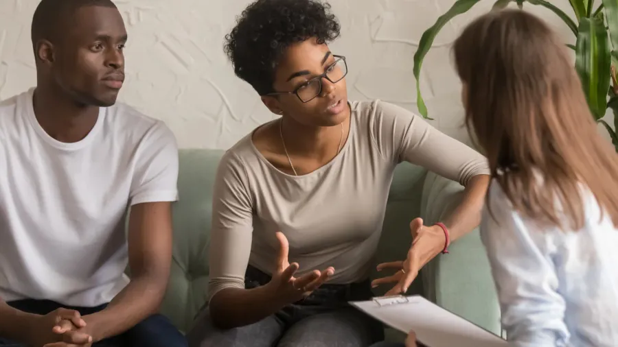 unhappy african wife talking to psychologist complaining on bad relationship