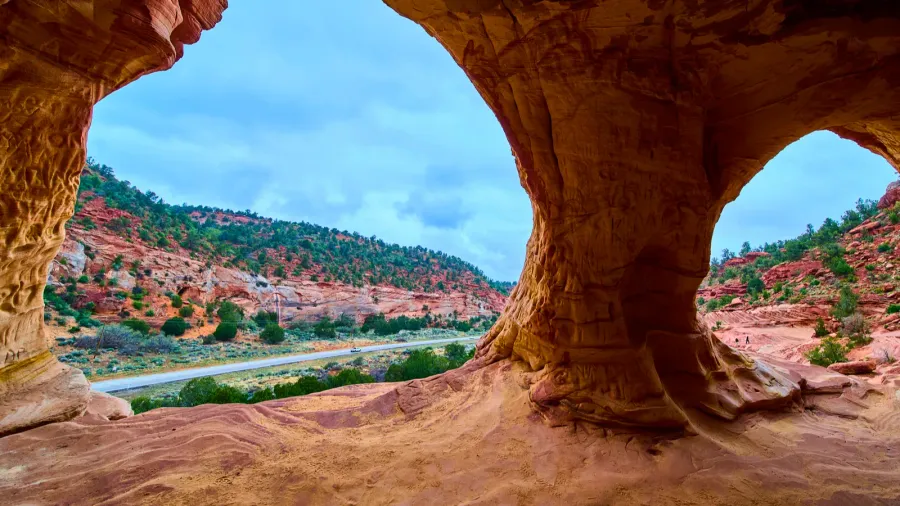view from inside a natural sandstone cave near kanab utah