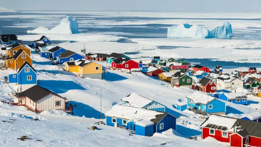 village overlooking sea with icebergs