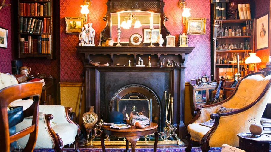 Cozy, vintage-style living room with a dark wood fireplace, yellow upholstered chairs, and warm lighting.
