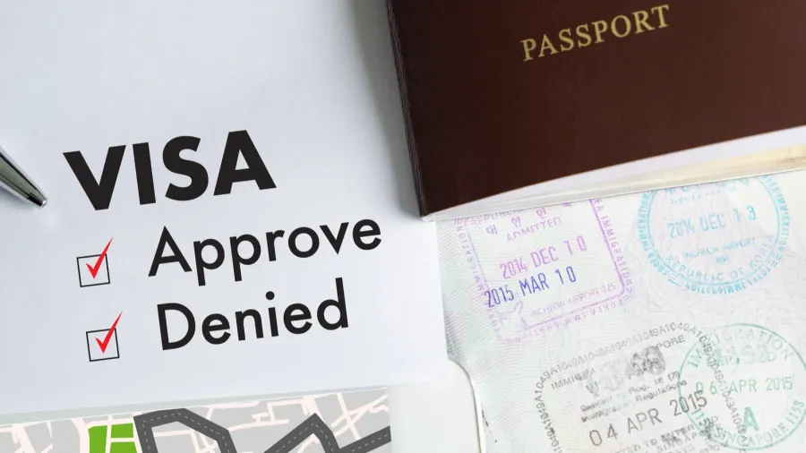 visa and passport to approved stamped on a document top