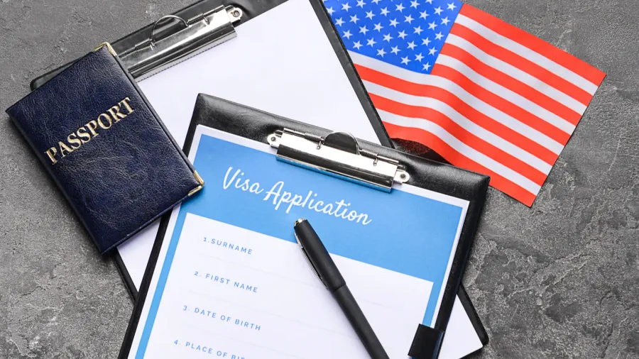 visa application form passport and usa flag on table concept