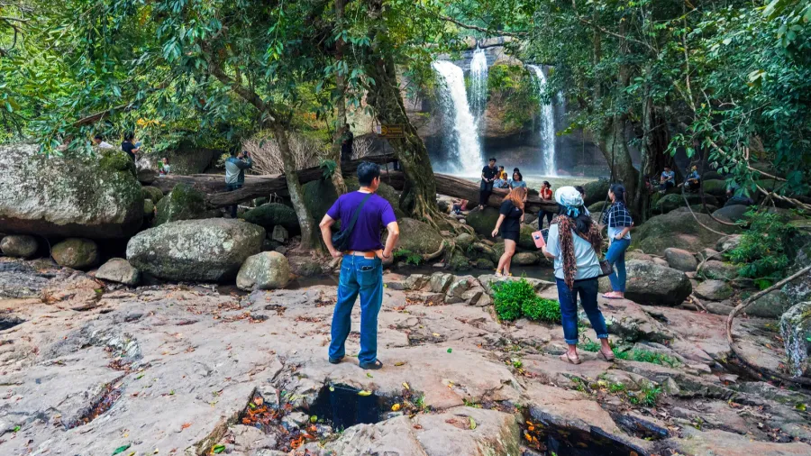 visitors approaching haew suwat waterfall in khao yai
