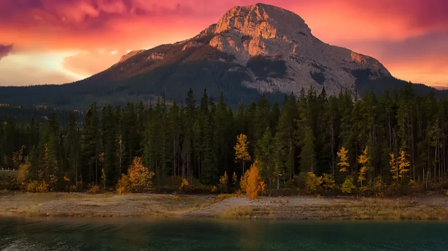 warm sunrise glowing over mountains at barrier lake