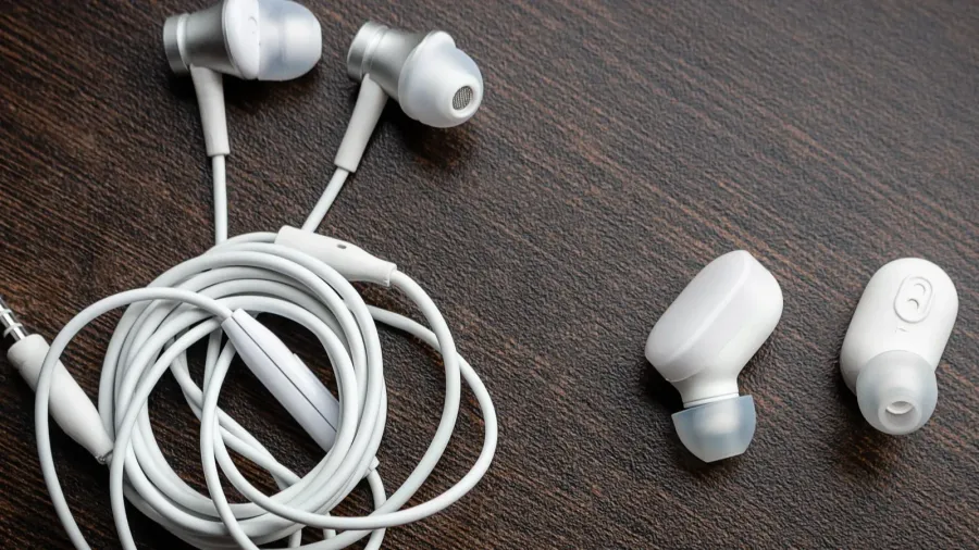 white wireless bluetooth headphones and wired tangled headphones closeup