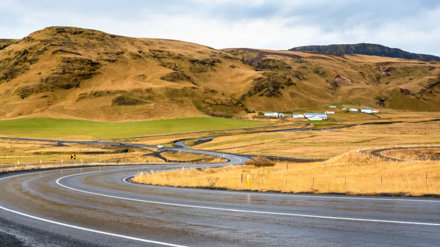 winding wet mountain road in iceland on a cloudy autumn