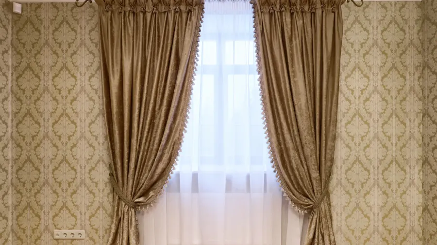 Luxe layered curtains with tie backs on a window.