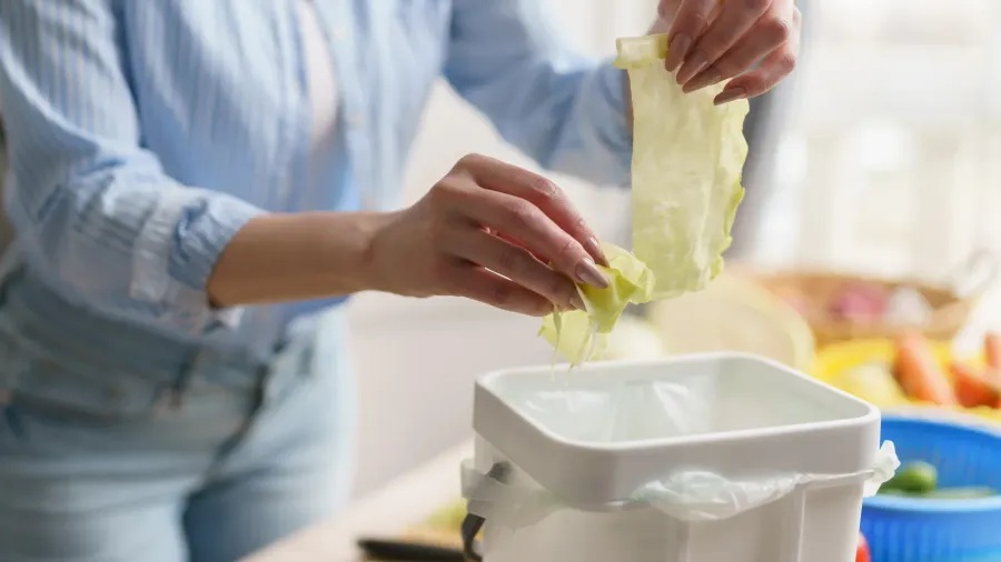 woman composting food leftovers at home female recycling organic waste
