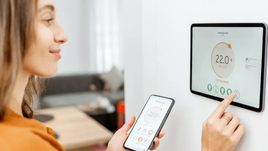 woman controlling heating with a smart devices
