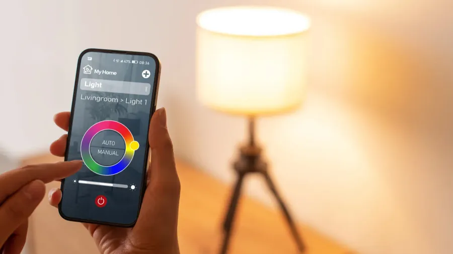 A close-up of a smartphone displaying a smart home lighting control interface, highlighting features for adjusting light settings.