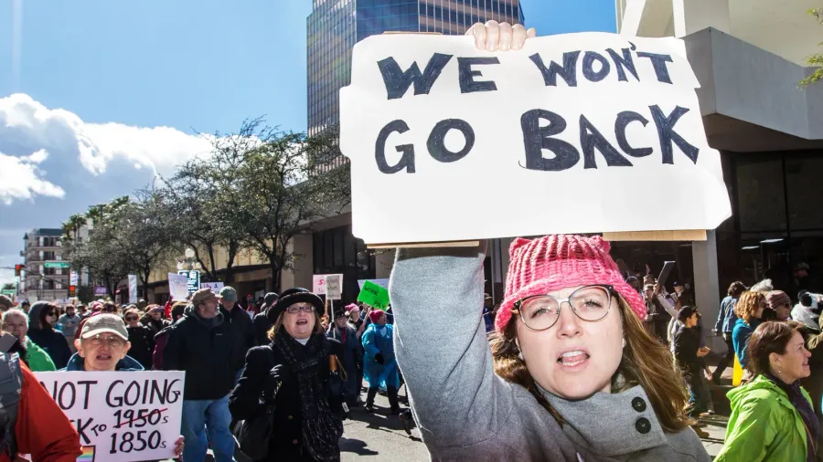 woman holding immigrant rights sign