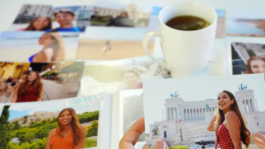 A woman looking at old photos from a trip.