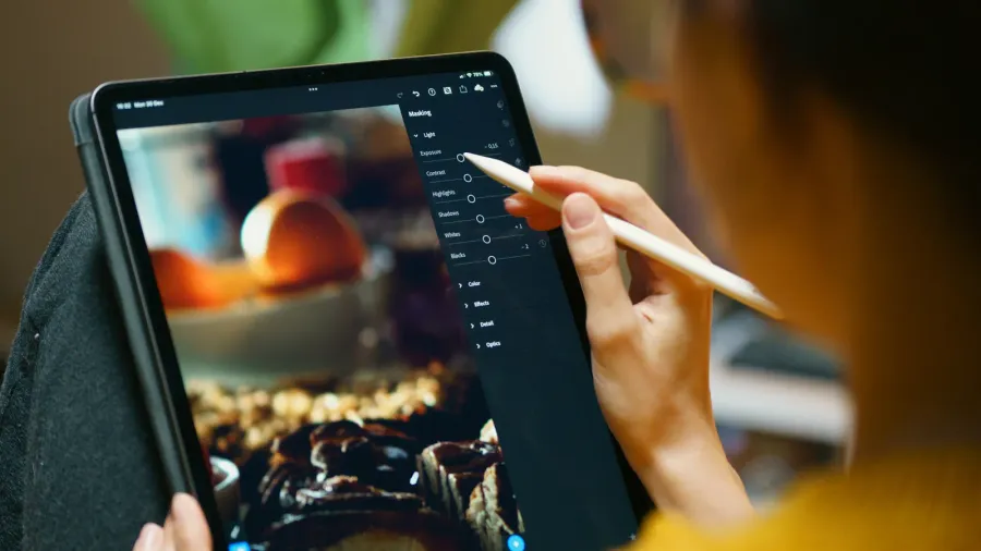 woman photo editing on digital graphic tablet lightroom software relax