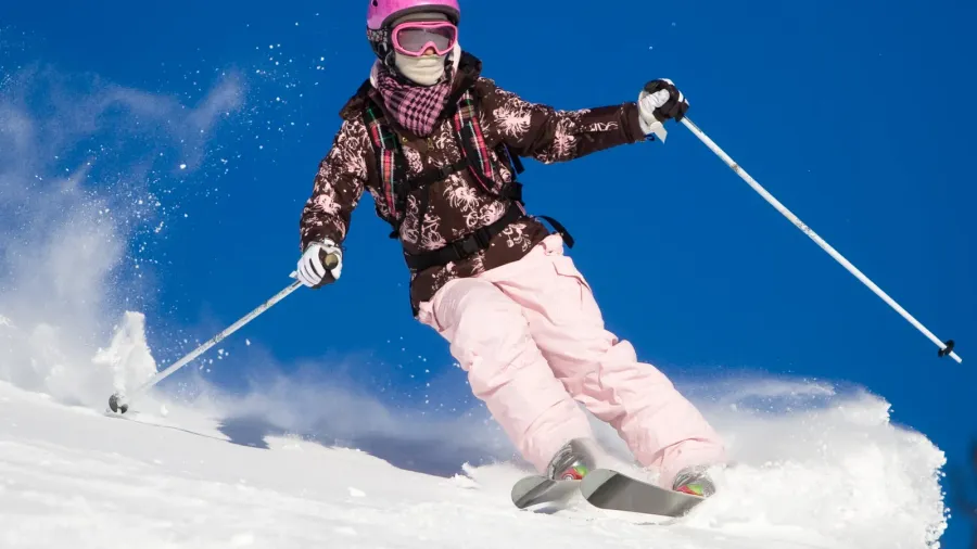 woman skiing fast vibrant sky