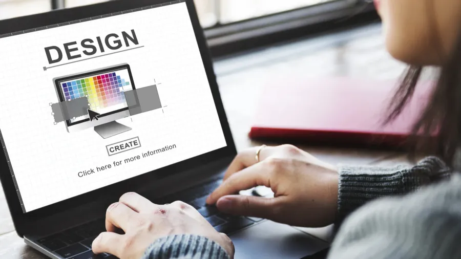 woman typing on laptop with design