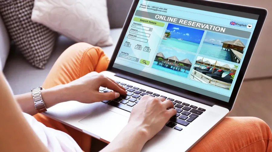 woman using laptop to book hotel online