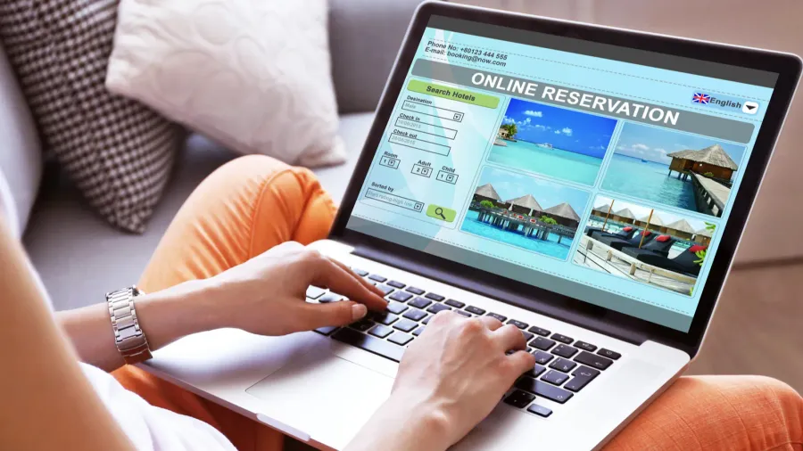 woman using laptop to book hotel online