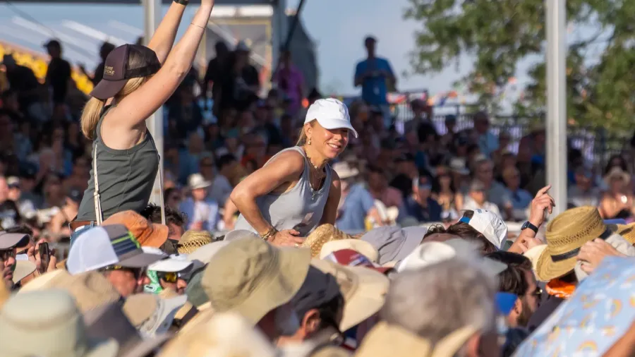 women seated above the crowd during a performance by the