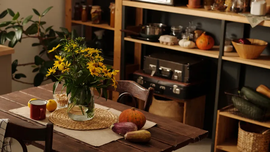 wooden table with bunch of wildflowers in vase vegetables mug/Cluttercore kitchen