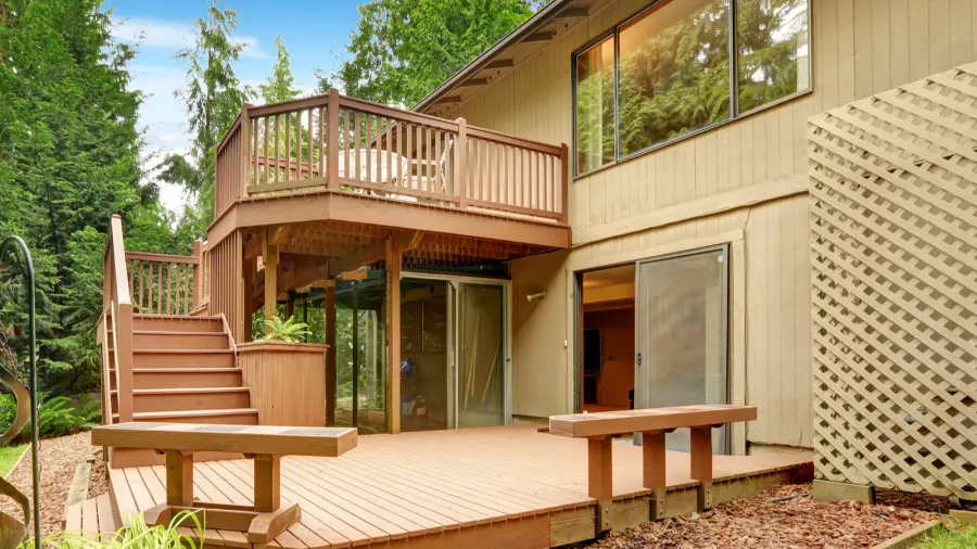 wooden walkout deck with patio and benches
