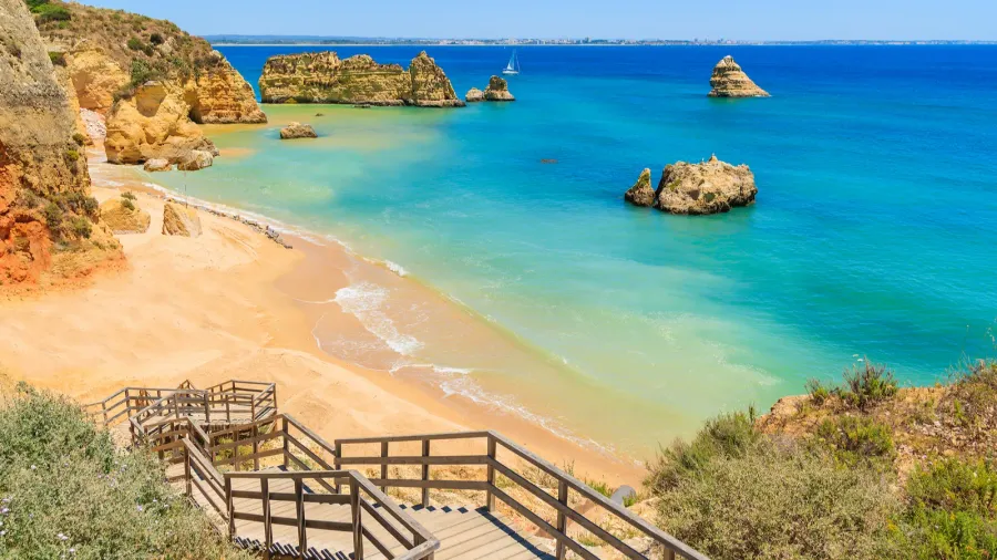 wooden walkway to famous praia dona ana beach