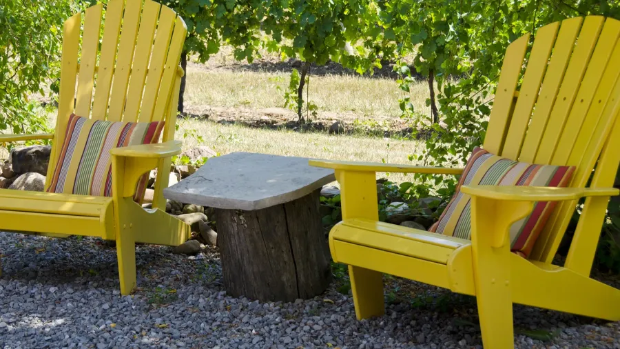 yellow adirondack chairs on a patio
