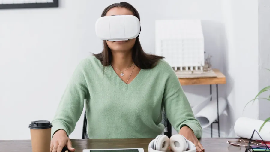 young african american architect in vr headset sitting at workplace