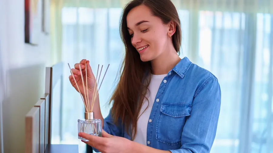 young happy smiling cute woman enjoying aroma and smell of