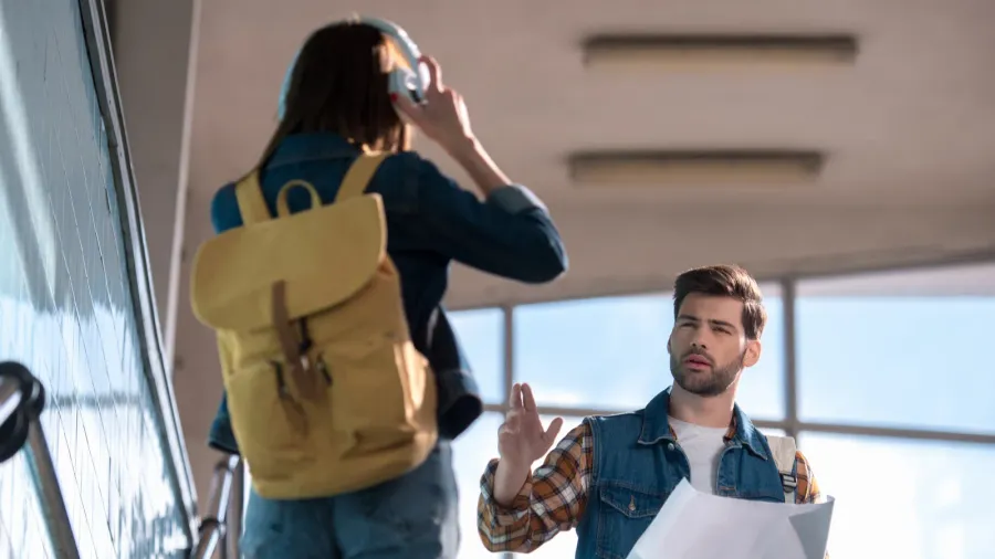 young male traveler with map in hand asking for help