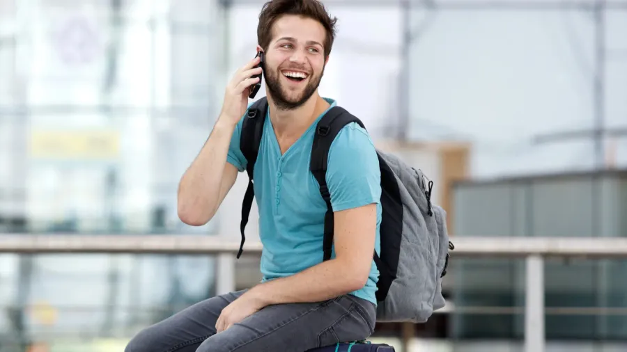 young man calling by mobile phone at airport
