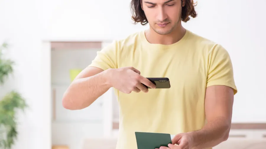 young man holding passport preparing for summer trip