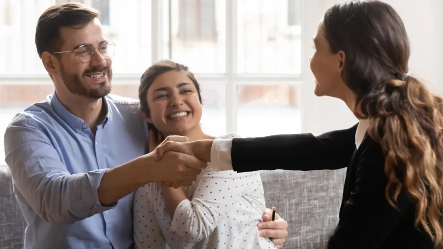 young spouse shaking hands with professional financial consultant
