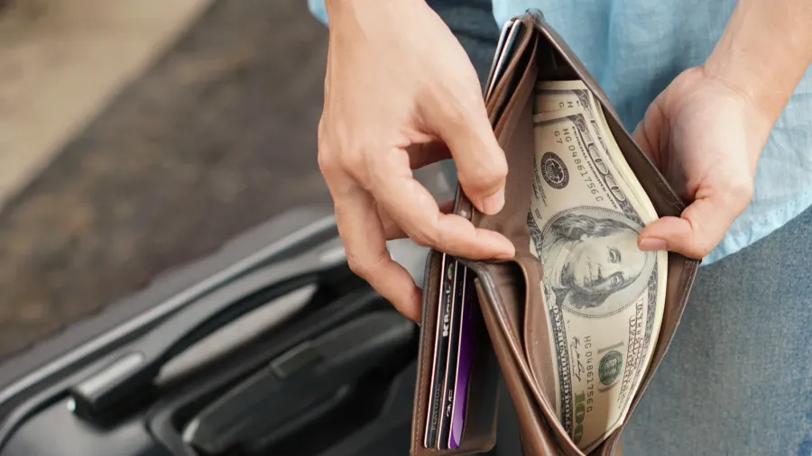 young woman backpacker traveler hands holding wallet dollar currency money