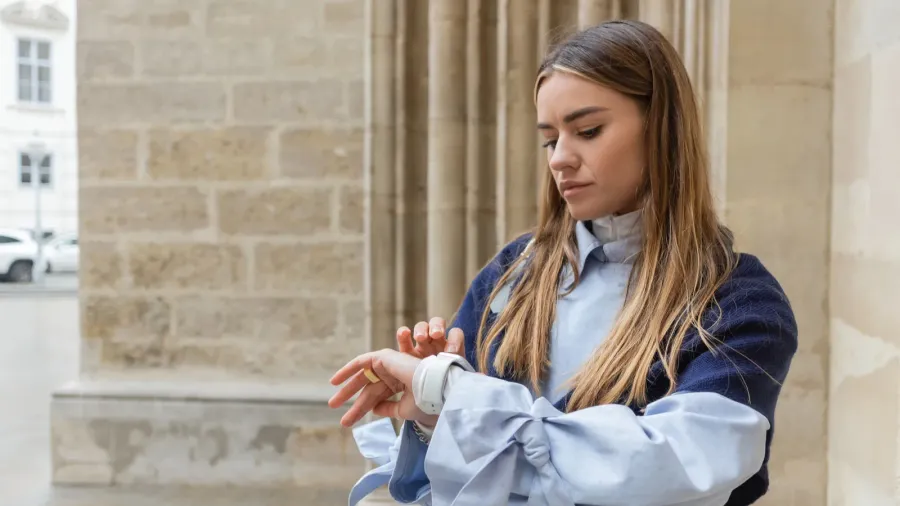 young woman with scarf on top of blue trench coat