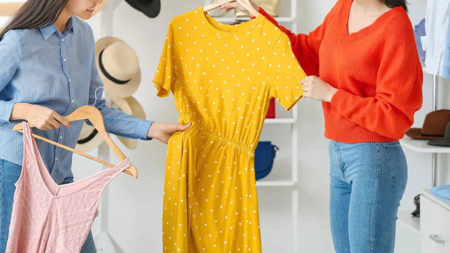 young women choosing clothes in modern store
