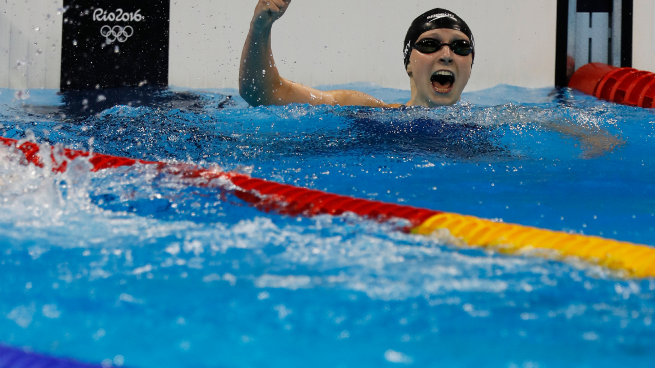 A swimmer cheering after winning