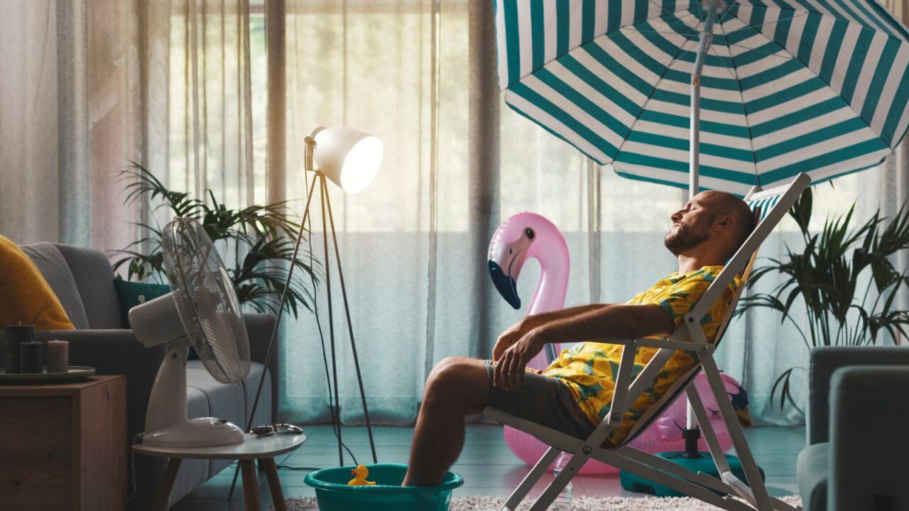 Man sitting under umbrella