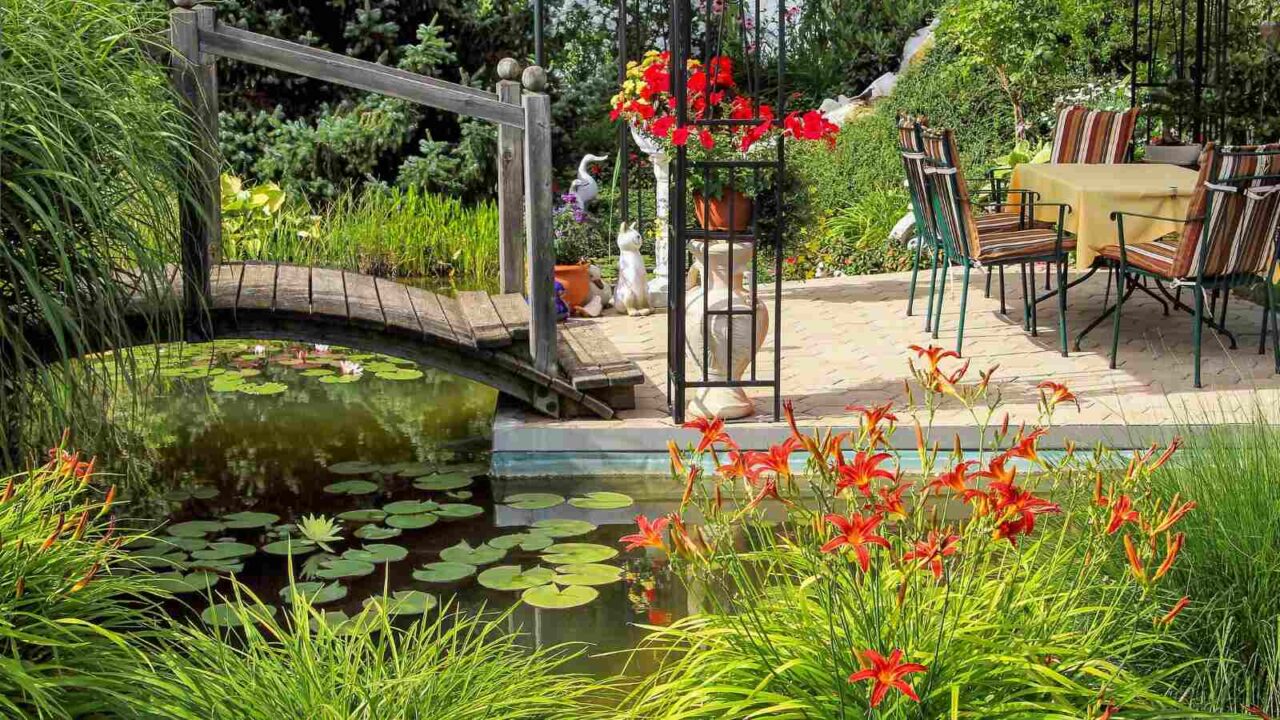 Outdoor pond with a wooden bridge and seating