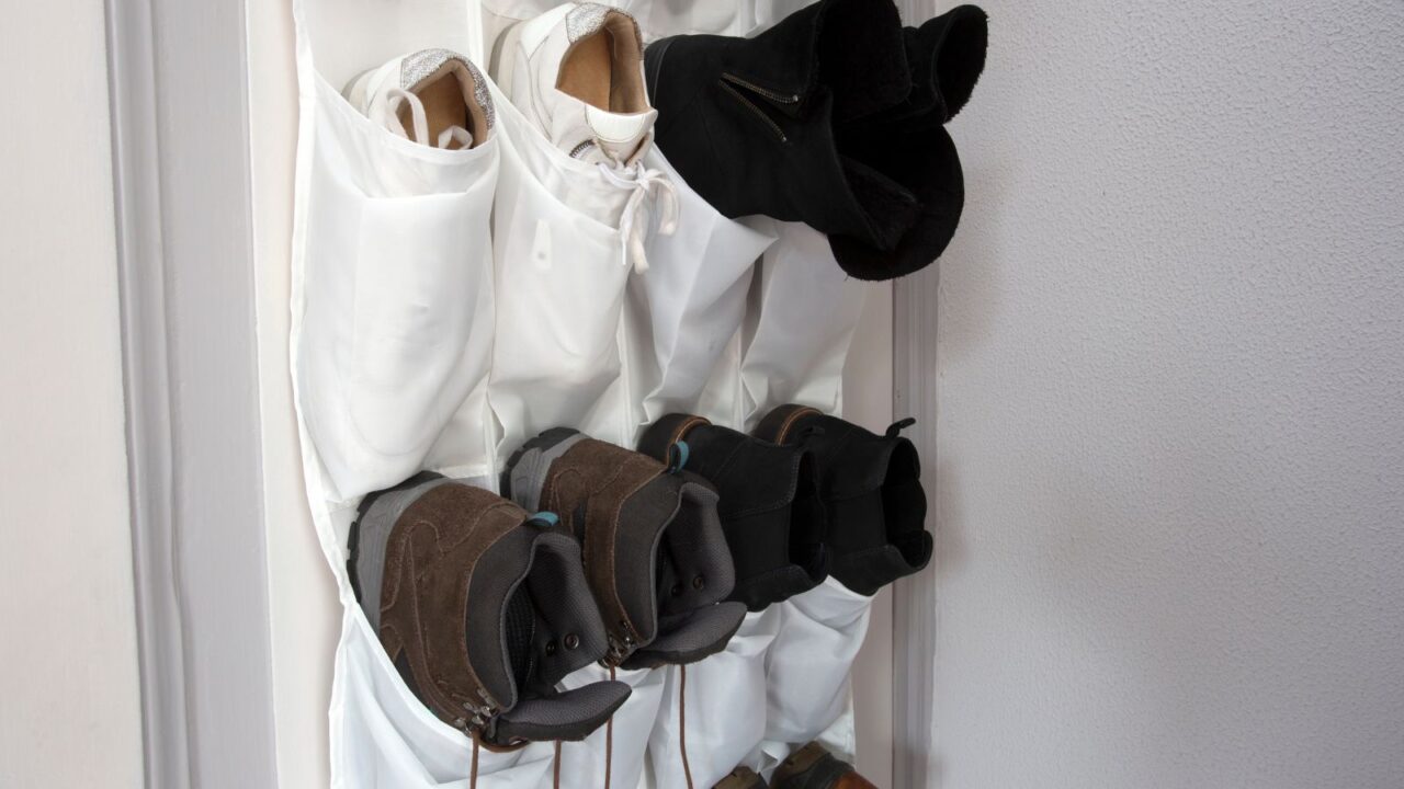 A door mounted organizer holding shoes.