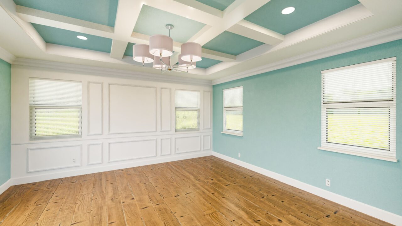 A light blue room interior with wooden flooring and coffered ceiling.