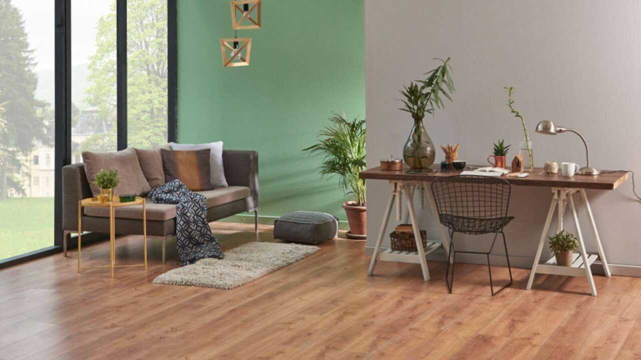 A living room with plants and sofas in mint green shade