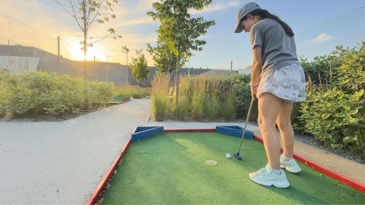 Girl playing mini golf