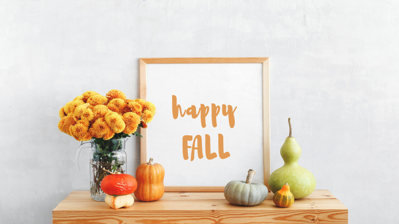 Fall decoration on mantel consisting of pumpkin, gourd and happy fall frame