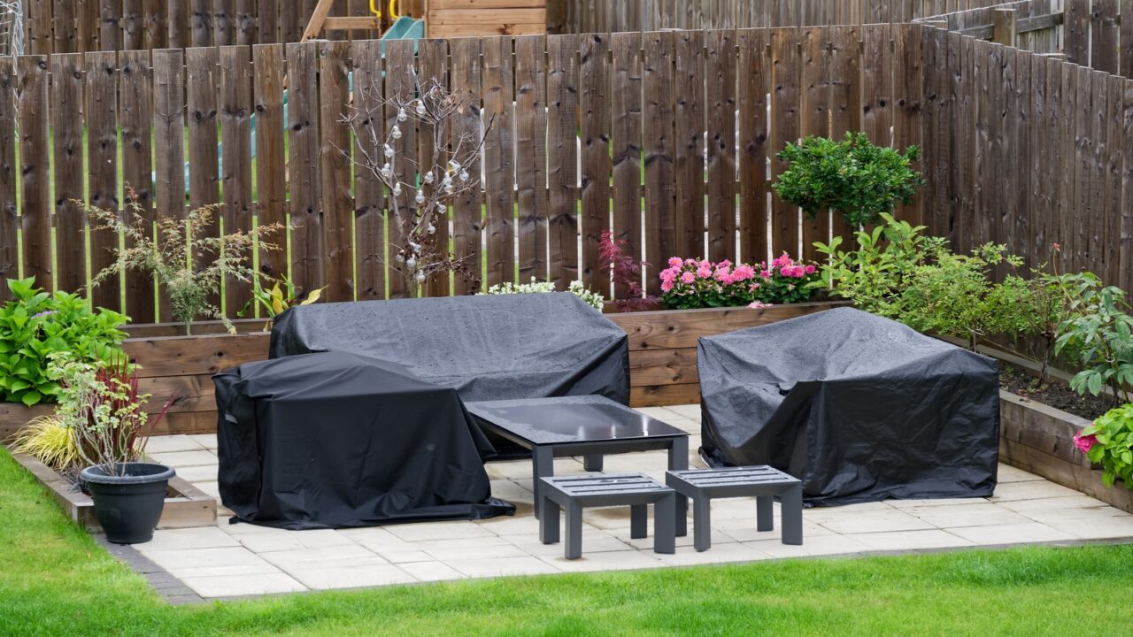 Black furniture cover on sofas in a garden