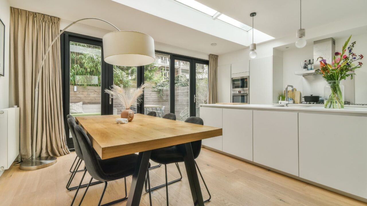 The rich interior of the living room of a modern house combined with a dining area kitchen