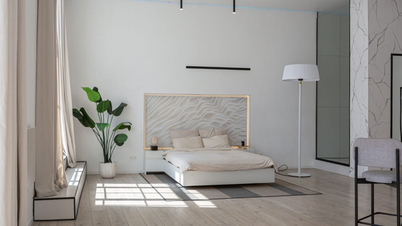 An elegant bedroom setup in white tones during daylight